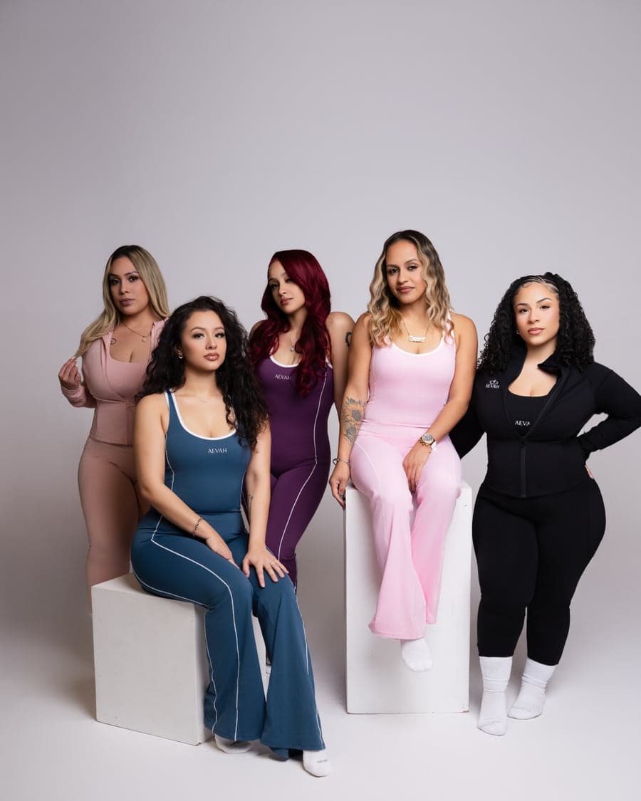 Five women in AEVAH one-pieces, every colorway